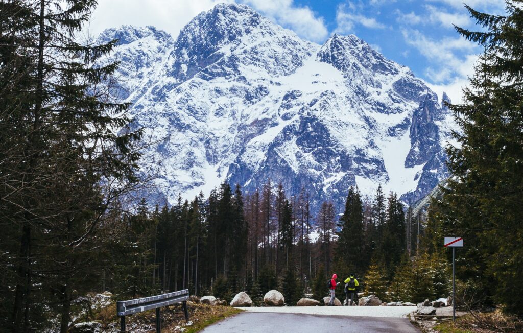 two tourist standing road near snowy mountain1111